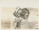Image of Eskimo [Inuk] girl with baby sister in hood